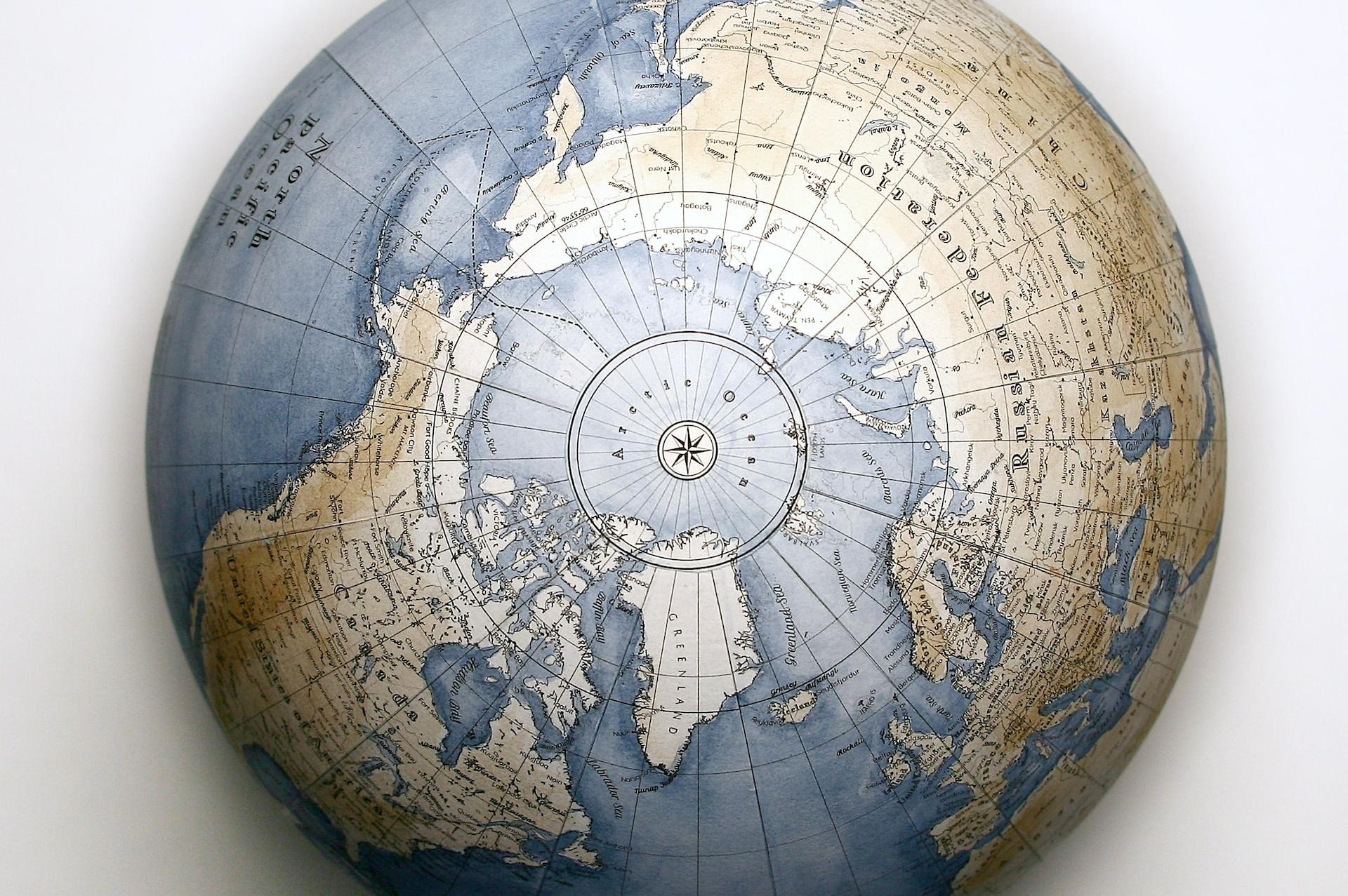 brown and black globe on white table